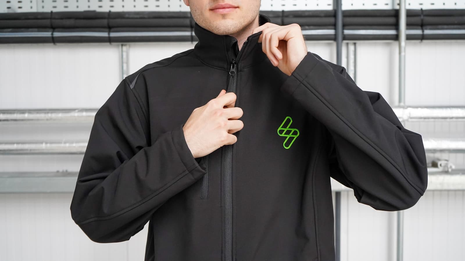 Embroidered left-chest logo on a softshell jacket for site teams